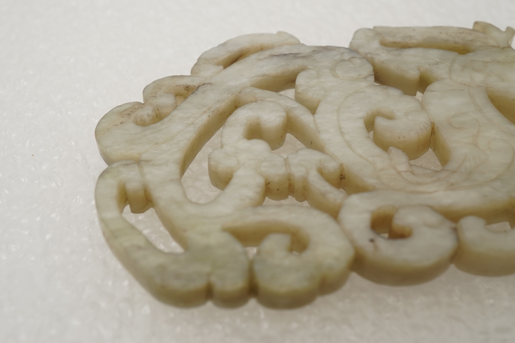 A Chinese white and grey mottled jade ‘chilong’ plaque, Ming dynasty
